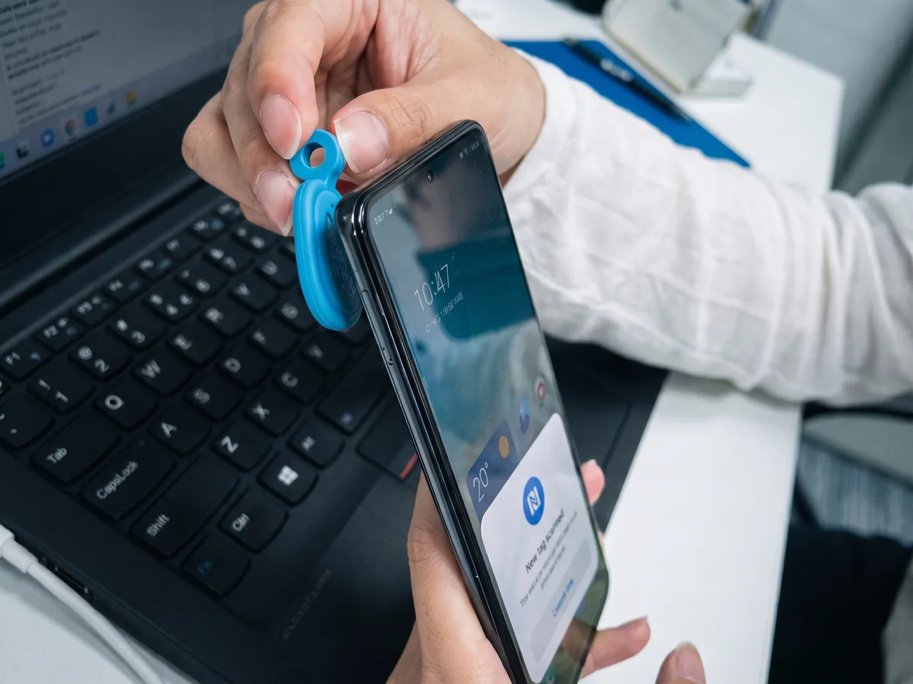 Test NFC : la médaille posée contre un téléphone qui affiche la lecture du tag.